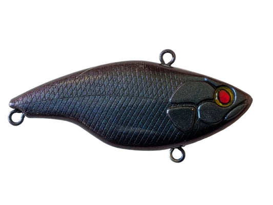 Fishing lure with a textured body.  Dark purple to Green colour transformation red eye on a white background