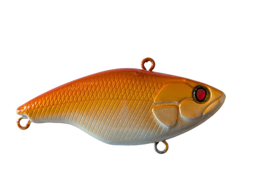 Yellow and orange fishing lure with a red eye on a white background